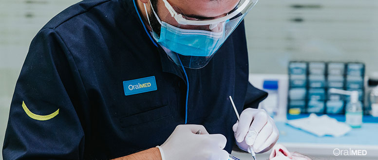 Dentista OralMED trata paciente em cadeira do dentista